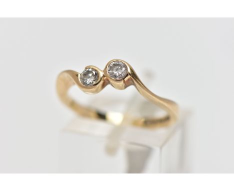 A 9CT YELLOW GOLD DIAMOND TWO STONE CROSSOVER RING, set with two round brilliant cut diamonds, each within a partial collect 