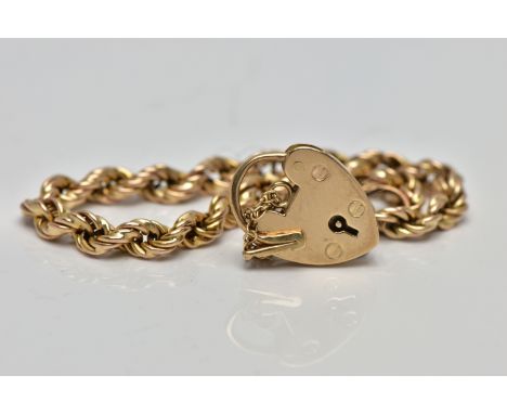 A 9CT GOLD ROPE TWIST BRACELET, hollow rope twist chain, fitted with a heart padlock hallmarked 9ct Birmingham 1981, with add