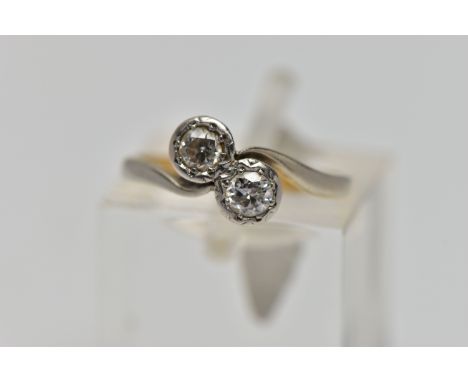 A YELLOW AND WHITE METAL DIAMOND RING, two round brilliant cut diamonds set in an illusion setting, toi et moi design ring le