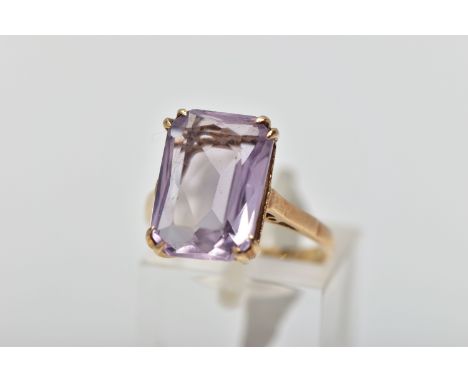 A 9CT GOLD AMETHYST SINGLE STONE RING, the rectangular shape amethyst measuring approximately 14mm x 10mm x 5.5mm, with openw