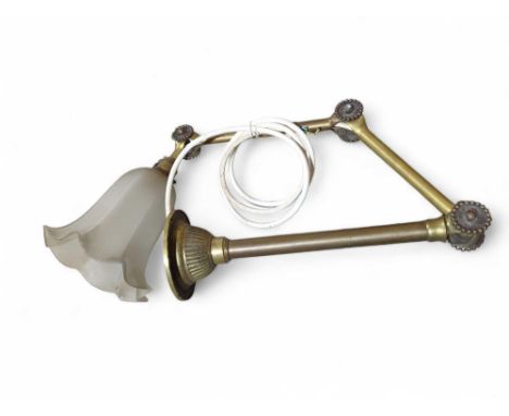An early 20th Century adjustable brass wall light with glass shade