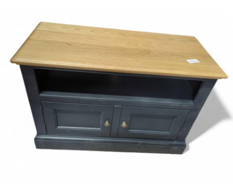 A modern TV unit, with a light oak top and slate blue base, an enclosed shelf with a two door cupboard below, 68cm high, 98.2