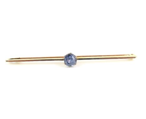 An early 20th century bar brooch, set with a light blue sapphire, marked '15ct' with white metal top, 1.8g gross