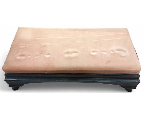 A low black painted bench, on four short cabriole legs, and pink upholstered seat, 39cm high, 108.5cm long