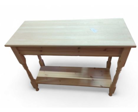 An unfinished pine two tier console table, on four turned legs, 75.5cm high, 96cm wide, 40.5cm deep