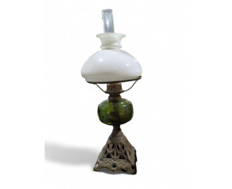 A Victorian oil lamp with white glass shade, green glass reservoir and metal base, height 48cms to top of shade