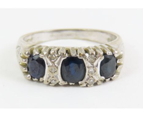 An 18ct white gold sapphire and diamond carved head ring, finger size Q, 7.4g gross