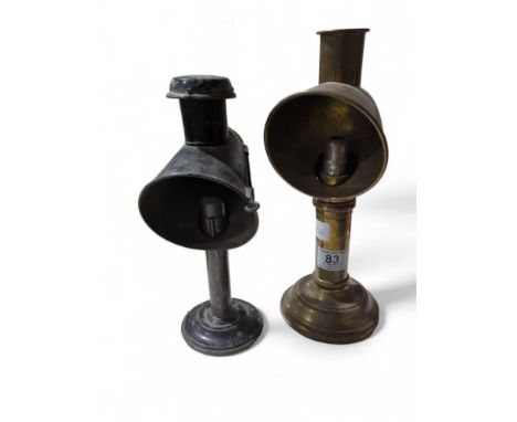 A 19th Century brass candle lamp, 31.5cms high together with a black painted metal candle lamp 27cms high (2)