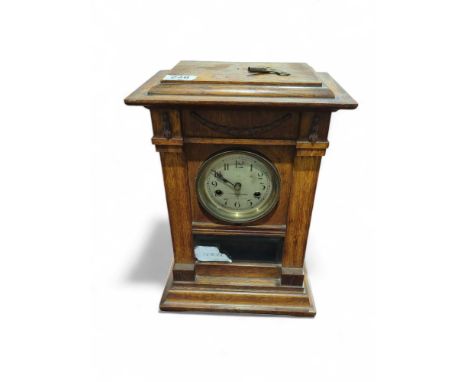 An Edwardian oak cased mantel clock with key, 38cms high
