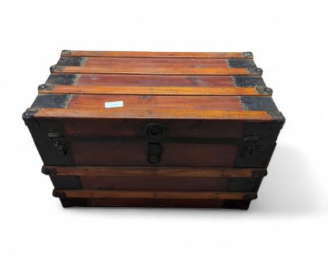 An early 20th century stained wood, metal bound travelling trunk, 56cm high, 87cm wide, 48.5cm deep