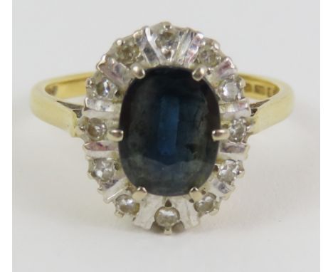 An 18ct gold sapphire and diamond cluster ring, each diamond with white gold bars between, finger size N, 4.3g gross