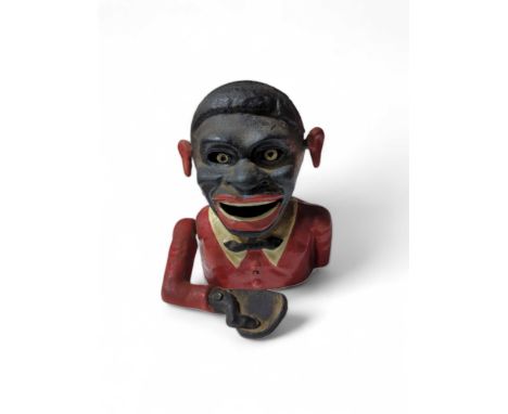 A painted metal American Starkie's money box 16cms high, These items are listed on the basis they are illustrative of a bygon