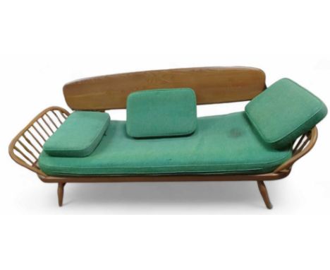 A mid 20th century beech and elm Ercol style day bed, with green upholstered cushions, solid back, 209.5cm long (max) (This i