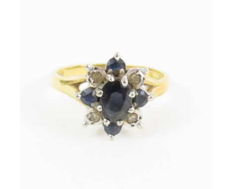 An 18ct gold sapphire and diamond flower type cluster ring, finger size M 1/2, 4g gross