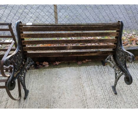A pair of black painted metal bench ends, with partial wood slatting, approximately 280cm long, 77.5cm high (max)