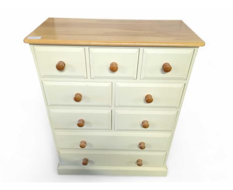 A modern light oak and cream lacquer chest of drawers, with an arrangement of ten drawers, 115cm high, 91.5cm wide, 43.2cm de