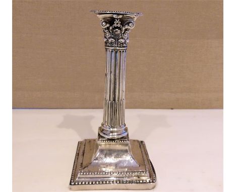 An C18th Georgian first period Old Sheffield Plate taper stick, standing on square foot with beaded borders, having an engrav