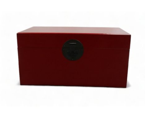 A 20th century Chinese red lacquer trunk - rectangular with brass hasp and bail handles, 77 x 46 x 38cm.
