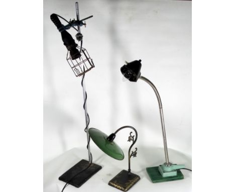 An art/industrial table lamp - the black rubber inspection lamp raised on a stand with clamps, together with two further tabl