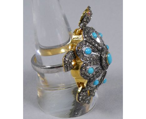 A large tortoise ring set with turquoise and diamonds and with ruby eyes - the turquoise weighing 0.62ct approximately, the r