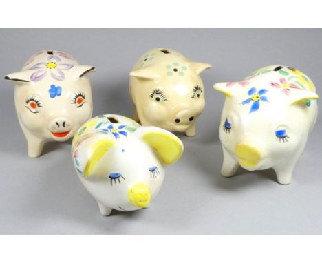 An Arthur Wood pottery piggy bank - decorated with blue, pink, and yellow flowers, width 19cm, together with two similar and 