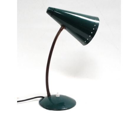 A vintage desk lamp - the green conical shade pierced with a band of stars to the mouth, on a brass gooseneck with a domed ba
