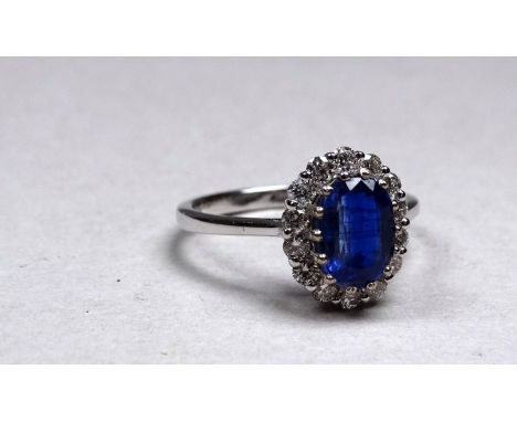 An 18ct white gold kyanite and diamond set cluster ring - the central oval kyanite weighing 1.77ct approximately, the diamond