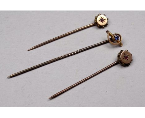 A 9ct gold sapphire set stock pin - together with two ruby set stock pins, weight 2.7g. (3)