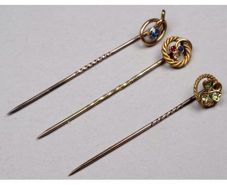 A 15ct gold stock pin - the rope twist setting with diamond, ruby and sapphire, together with two other pins, weight 4.3g. (3