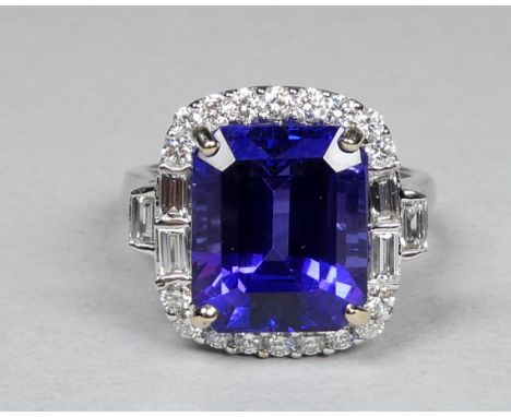 An 18ct white gold ring set tanzanite and diamonds - the central step cut tanzanite weighing 7.50ct approximately, surrounded