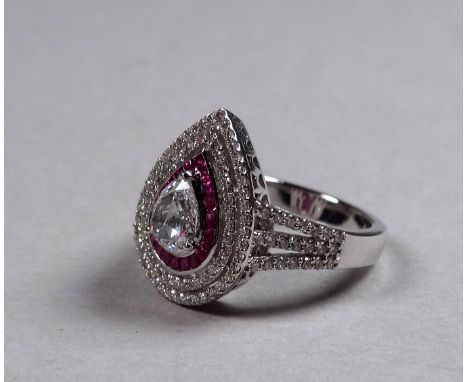 An 18ct white gold diamond and ruby set ring - the central pear shaped rose cut diamond weighing 0.52ct approximately, the ci
