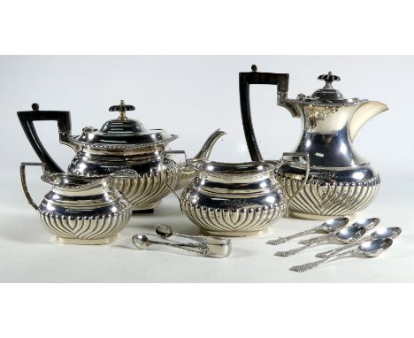 A silver four piece tea service - Sheffield 1894, part gadrooned with ebonised fittings, comprising a teapot, a hot water jug