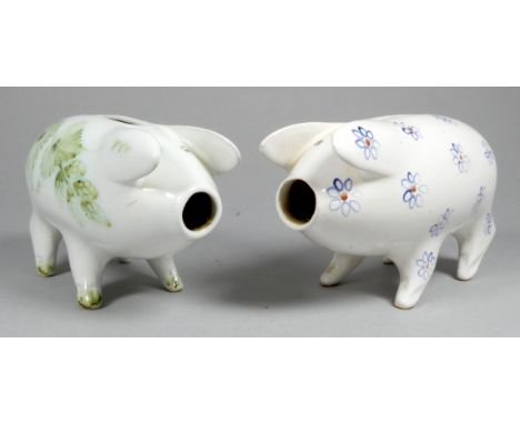A Rye Pottery piggy bank - decorated with blue flowers, width 14cm, together with another similarly decorated with hops. (2)