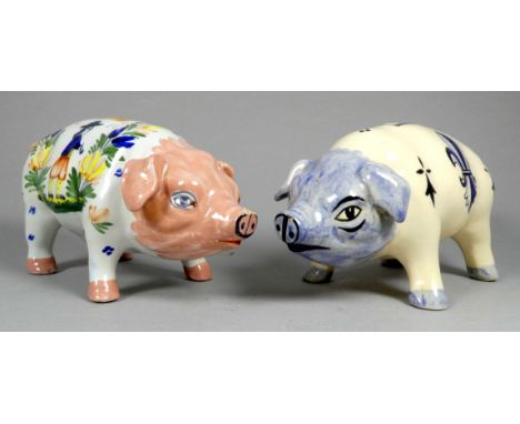 A Quimper pottery piggy bank - decorated with flowers, width 21cm, together with another Quimper pottery pig. (2)