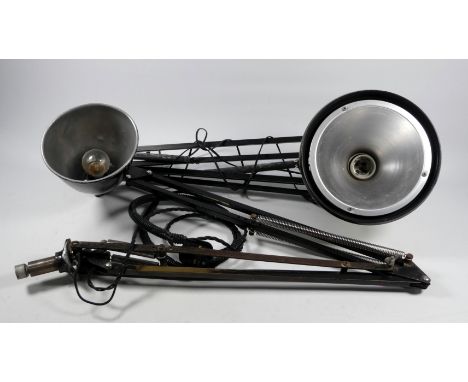 In the manner of Herbert Terry - a black finished articulated work light, together with another similar by Fase. (2)
