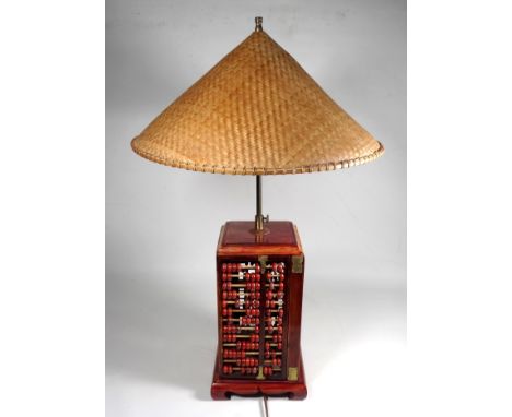 A 20th century oriental table lamp - of square form with abacus panels and a conical rafia shade, height 70cm.