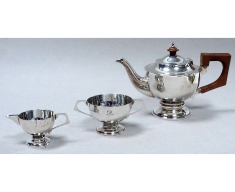 A silver three piece tea service - Brimingham 1907, engraved with the letter R, raised on circular bases, weight 345g.