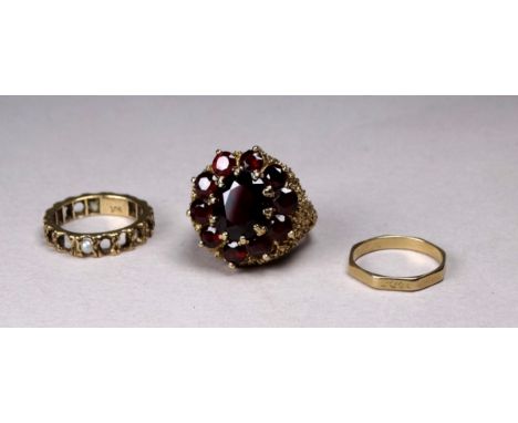 A 9ct gold garnet cluster ring - claw set with a pierced textured mount, together with two further 9ct rings, weight 12.2g.