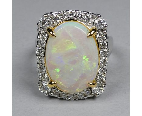 An 18ct white and yellow gold ring set opal and diamonds - the central oval opal weighing 3.96ct approximately, surrounded by