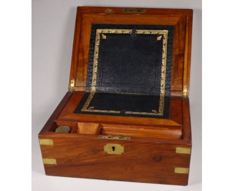 A Victorian walnut writing slope - with a vacant cartouche and brass binding, the interior with leather slope, inkwell and se