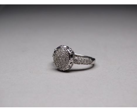 A 9ct white gold diamond ring - the oval cluster ring with diamond set shoulders, size N, weight 5.4g.