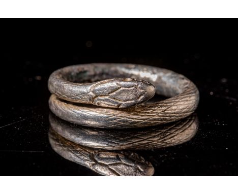 Ca. AD 100 - 300 Romano-Egyptian silver ring consisting of a single band that was hammered and shaped into the form of a serp