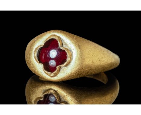 Ca. AD 600 - 700 A Merovingian gold finger ring with a round hoop, enlarged on the shoulders to form a large bezel. The bezel