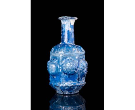 Ca. 100 BC - AD 100 A lovely Roman free-blown, semi-translucent glass unguentarium with a vibrant blue hue. The glass has a r