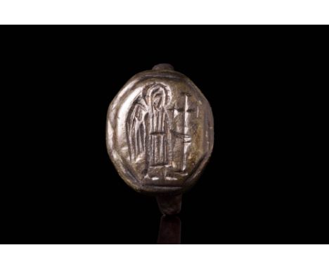 Ca. AD 300 - 700 A Byzantine ring crafted from bronze. The ring has a round hoop that smoothly transitions into a flat sectio