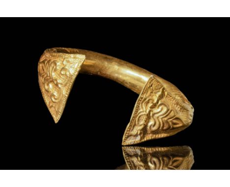 Ca. AD 600 A stunning Byzantine gold bracelet. The design features a large ring connected with two wide and flat finials, eac