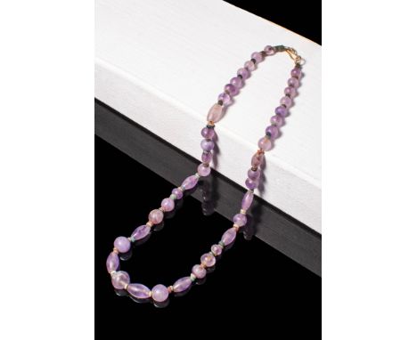 Ca. 300 - 100 BC A Hellenistic necklace with amethyst beads, alternating with seed shaped faience beads. Restrung. Size: 205/