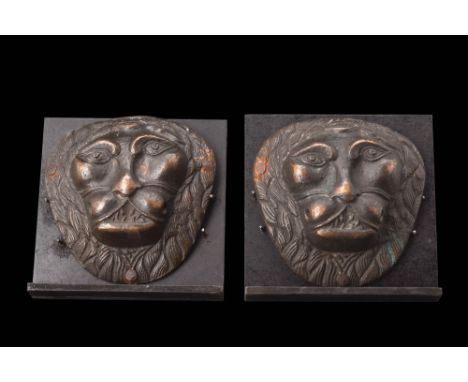 Ca. AD 1700 - 1800 A pair of bronze mounts depicting lion heads facing forward. Both feature almond-shaped eyes, visible teet