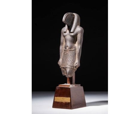 Late Period, Ca. 664 - 332 BC A magnificent basalt stone statuette portraying the deity Thoth. He is characterised by an upri