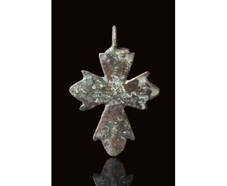 Ca. AD 400 - 600 A Byzantine bronze cross pendant with stylised flower-shaped arms, decorated with five dots representing the